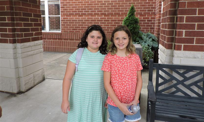Two students smile